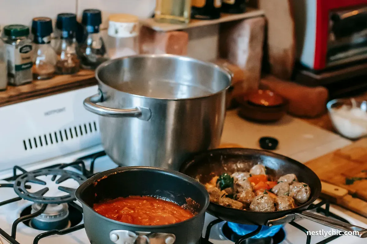 Several pans cooking at once on a four-burner gas stove