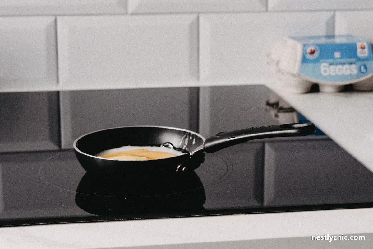 A single frying pan on an induction hob in a modern kitchen