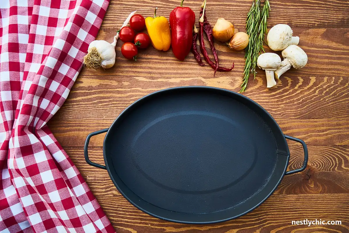 A clean cast iron pan on a wooden table with fresh vegetables