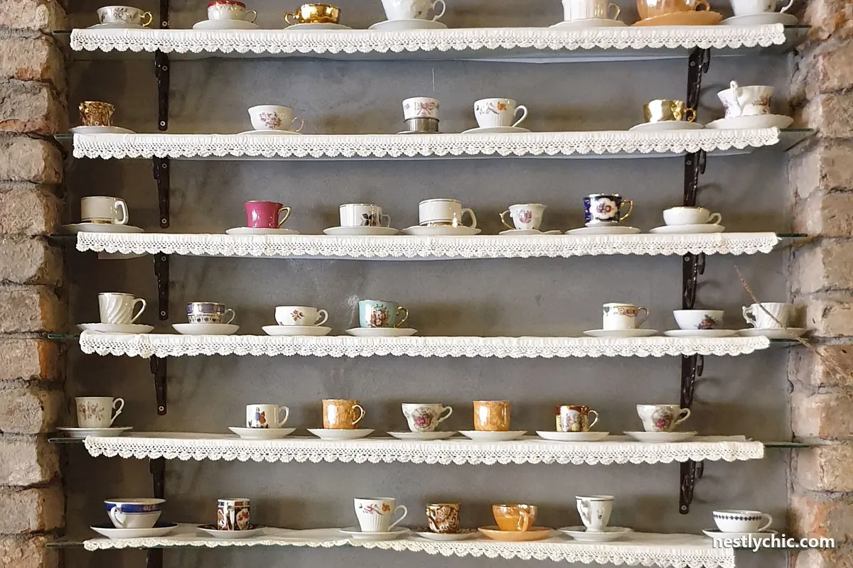 Vintage porcelain cups displayed on an antique shelf