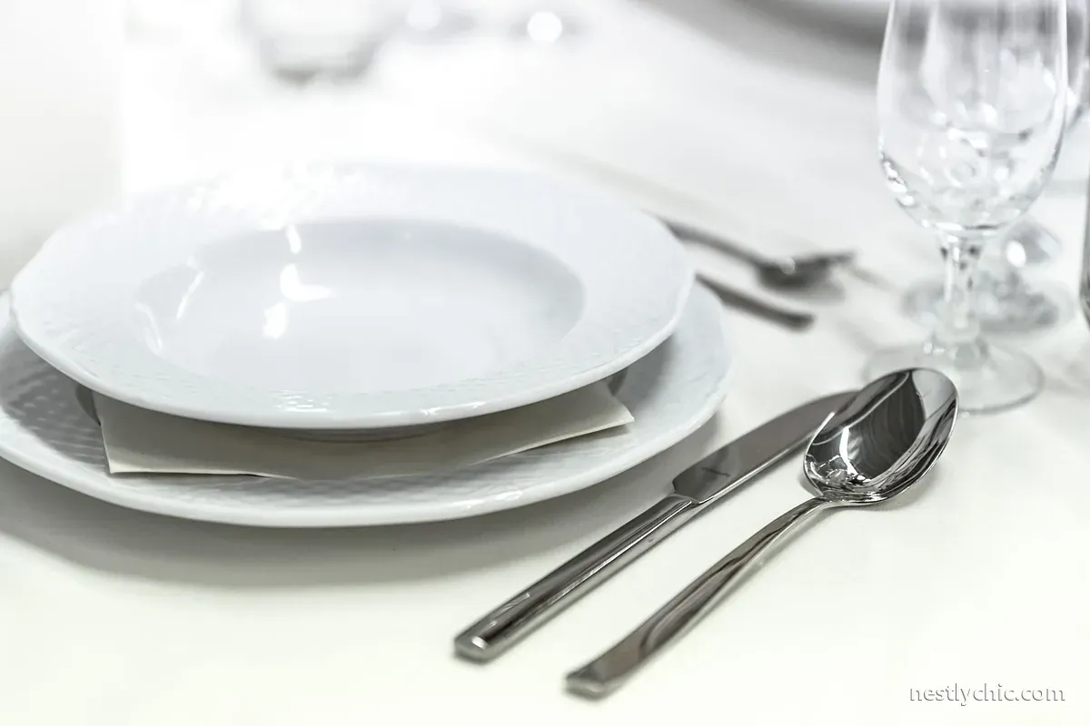 Dining table with porcelain plates and silver cutlery