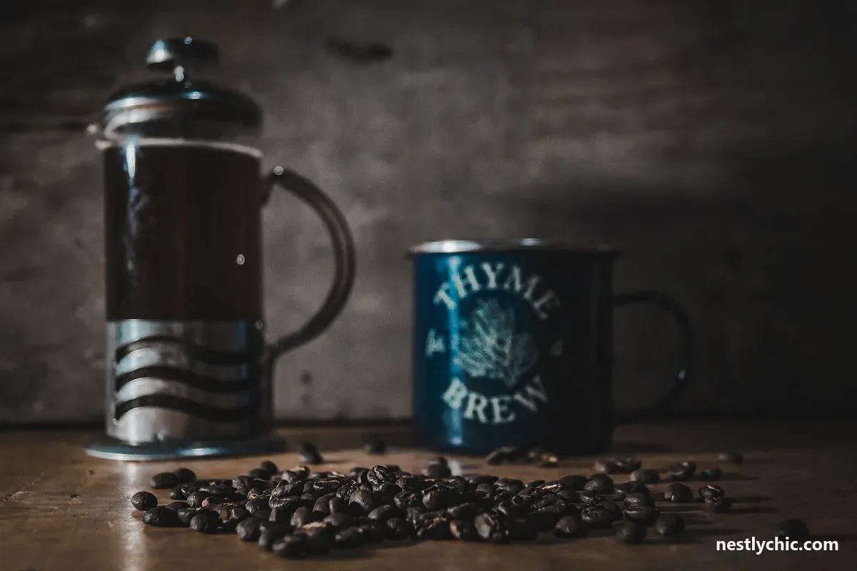 French press with a mug and coffee beans