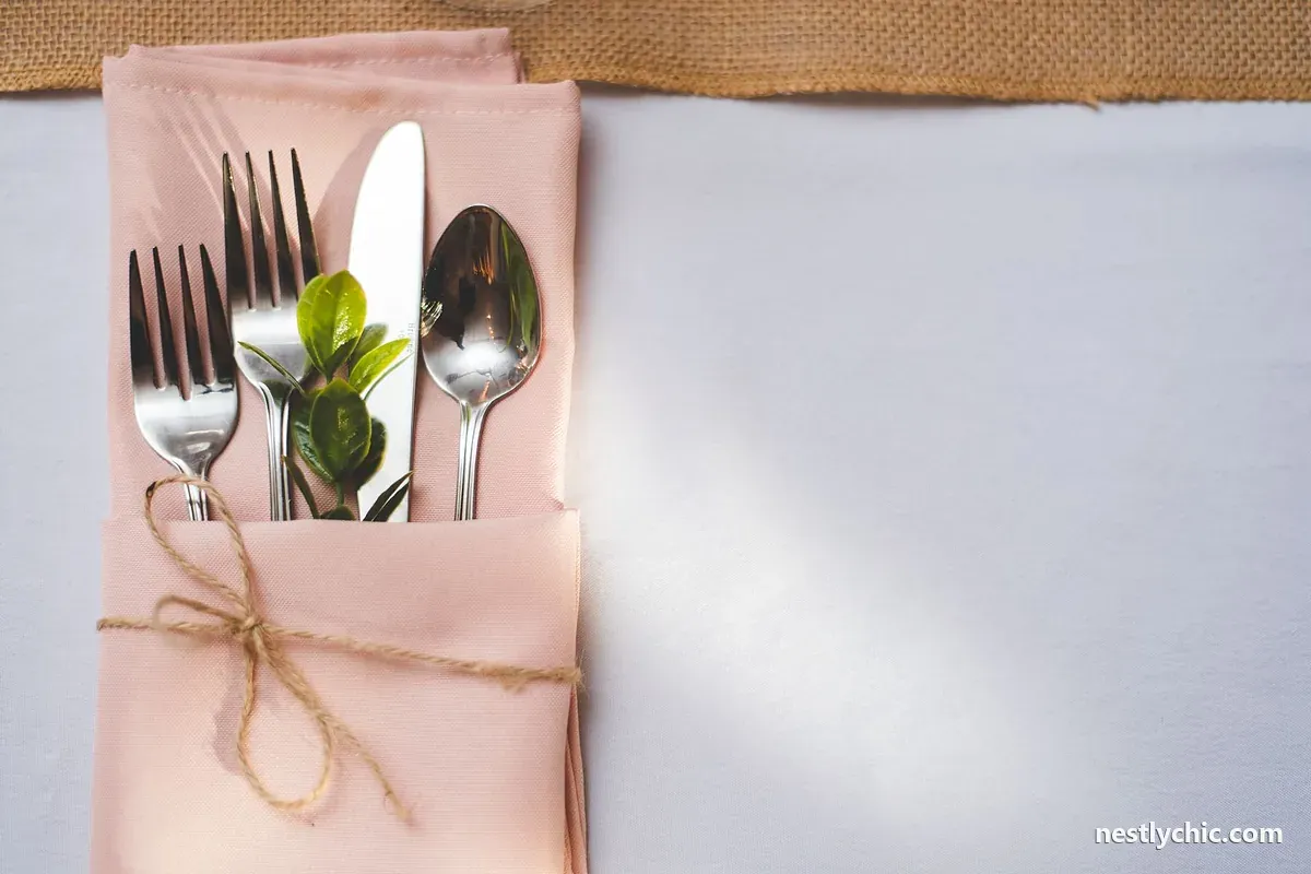 Cutlery with a green sprig on a pastel napkin
